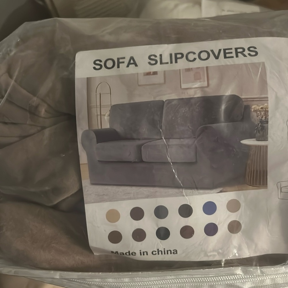 Tan sofa slip cover new in package. Package is slightly damaged.